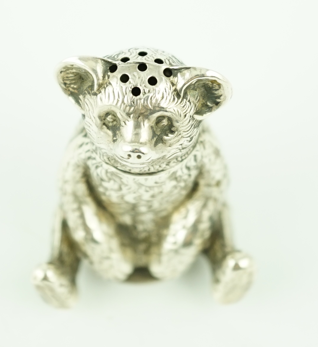 An Edwardian novelty silver pepperette modelled as a seated bear, Crisford & Norris